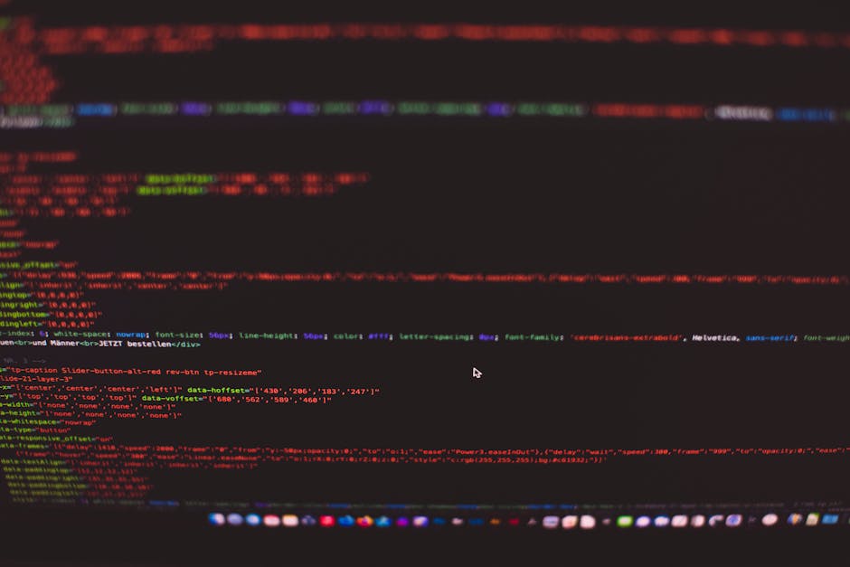 A close-up view of a computer screen displaying HTML and CSS code, with the code editor showing lines of markup such as <html>, <head>, <title>, and <link> elements. The dark-themed interface features